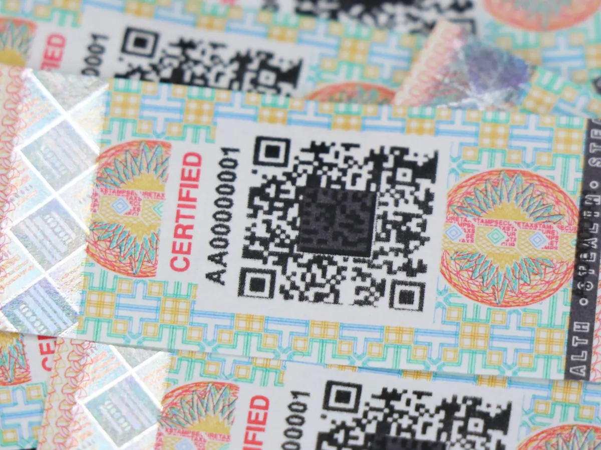 Printed excise stamps in close-up, showing guilloché line work and serial numbering