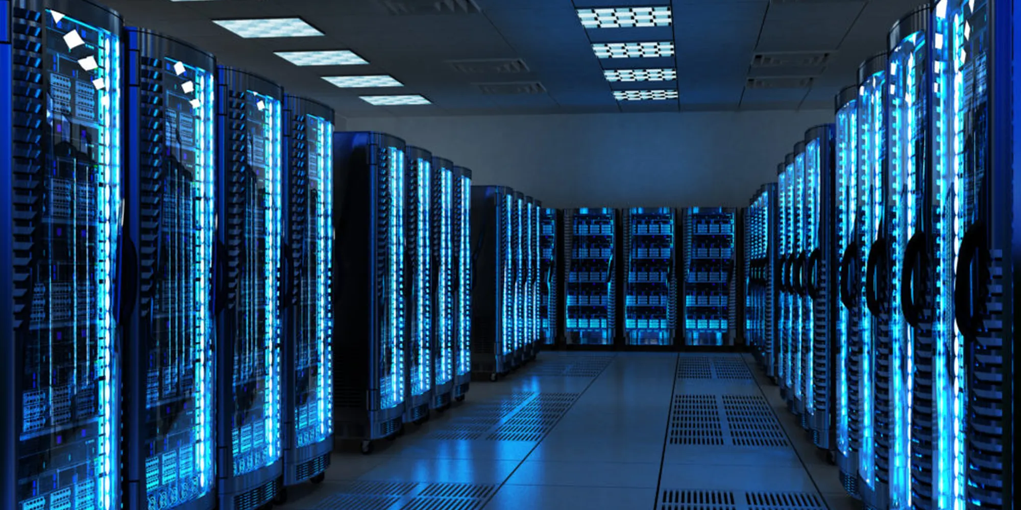 A data hall lit in blue, racks receding down a corridor
